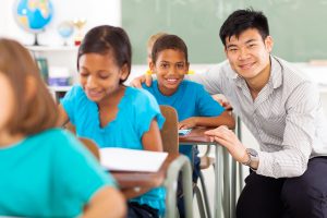 Teacher helping a student with reading